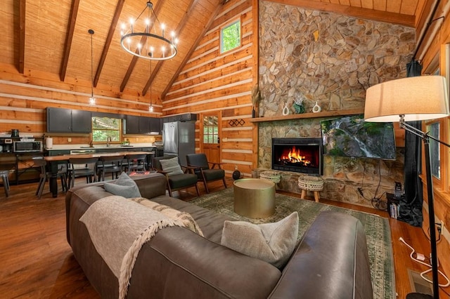 living room with a chandelier, a fireplace, wood finished floors, wood ceiling, and beamed ceiling