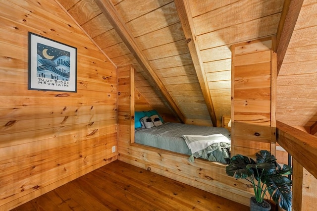 unfurnished bedroom with hardwood / wood-style flooring, wood ceiling, wooden walls, and vaulted ceiling