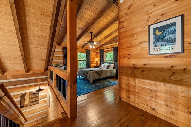 bedroom with lofted ceiling with beams, wood walls, wood ceiling, and hardwood / wood-style floors