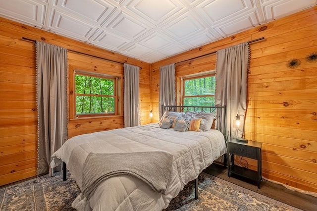 bedroom featuring wood walls and an ornate ceiling