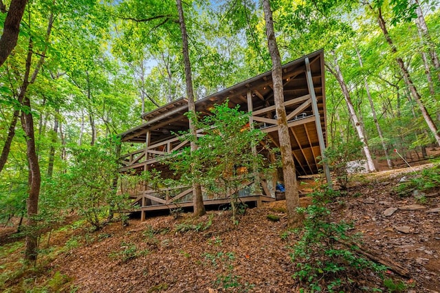 view of outbuilding featuring a view of trees