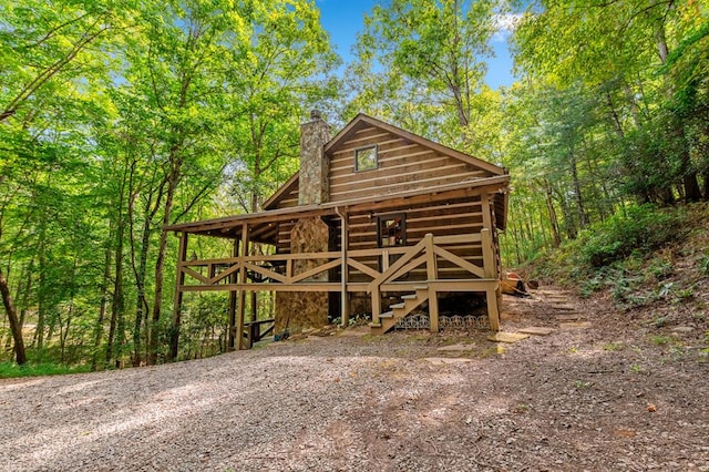 view of outbuilding with a forest view