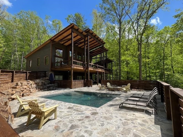 back of house featuring a balcony and a patio