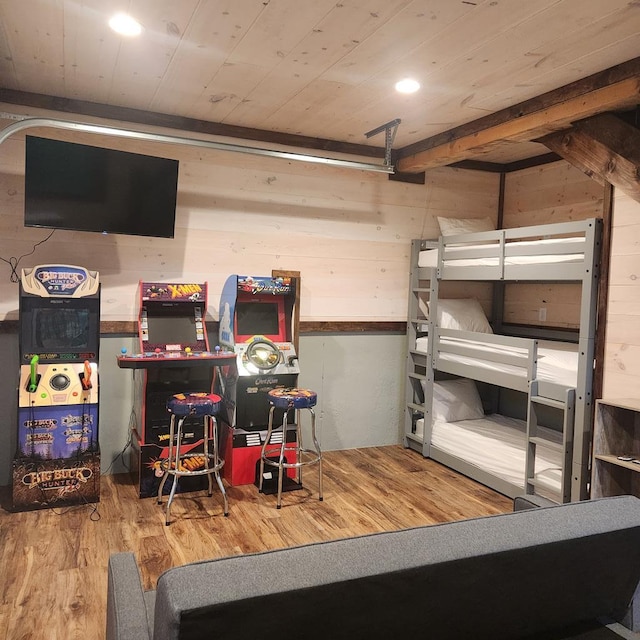 bedroom featuring wood ceiling, wooden walls, and wood-type flooring