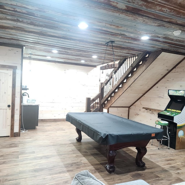 rec room with hardwood / wood-style floors, wooden walls, and billiards