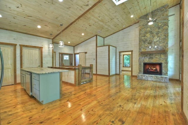 kitchen with pendant lighting, a center island, wood ceiling, and light hardwood / wood-style flooring