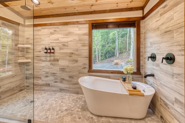 bathroom with wood walls and separate shower and tub