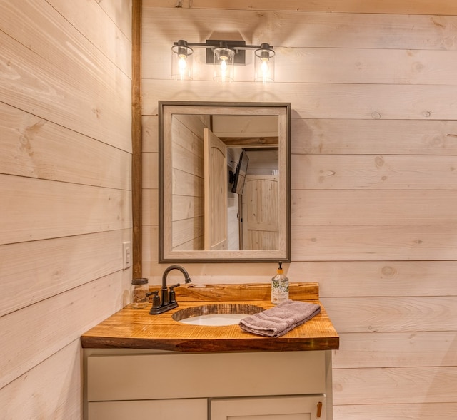 bathroom with wood walls and vanity