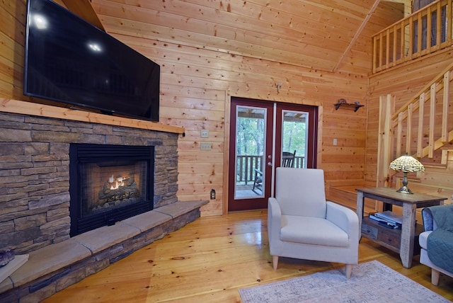 sitting room featuring wooden ceiling, a fireplace, stairs, and wood-type flooring