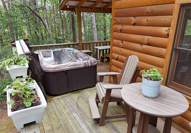 wooden deck featuring area for grilling and a hot tub