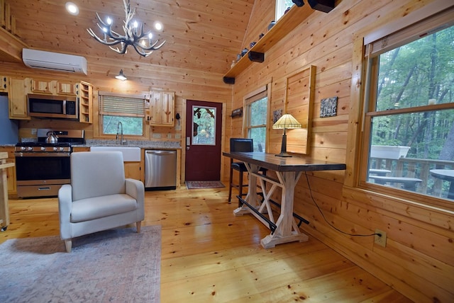 kitchen with wooden walls, light countertops, stainless steel appliances, a wall mounted AC, and a sink