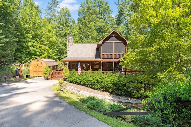 view of front of home with a storage shed