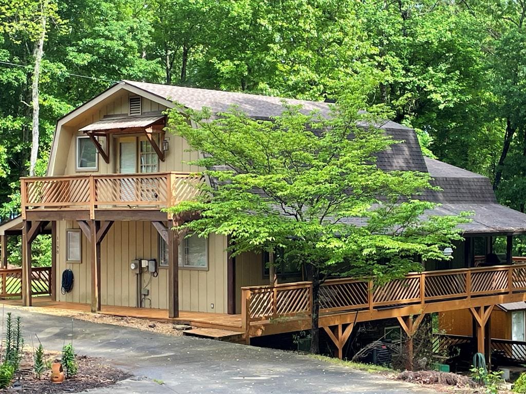 exterior space with a wooden deck and a shingled roof