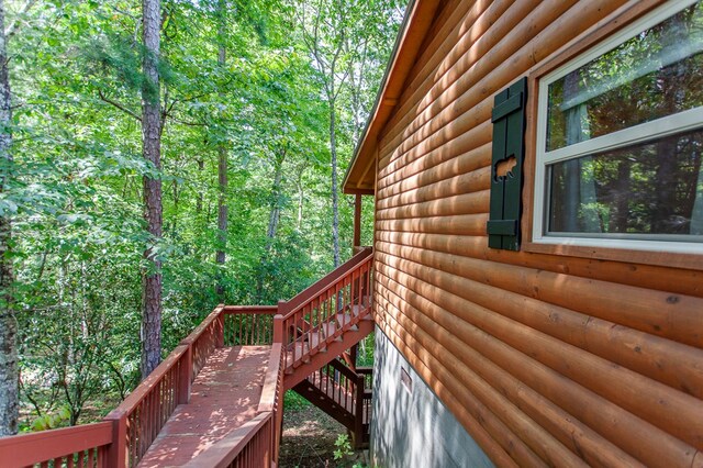 view of side of home featuring a wooden deck