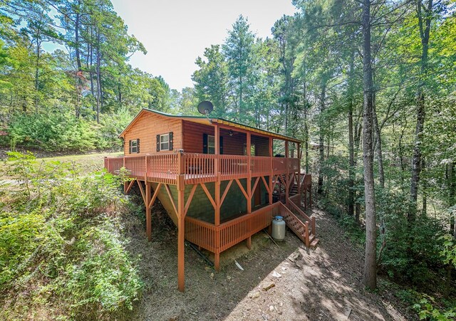 back of house featuring a wooden deck