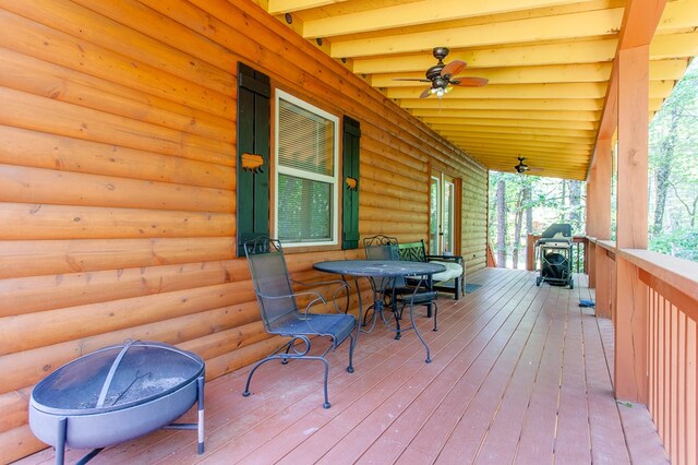 wooden terrace with a grill