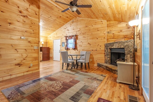 living room with wood ceiling, ceiling fan, and light wood-type flooring