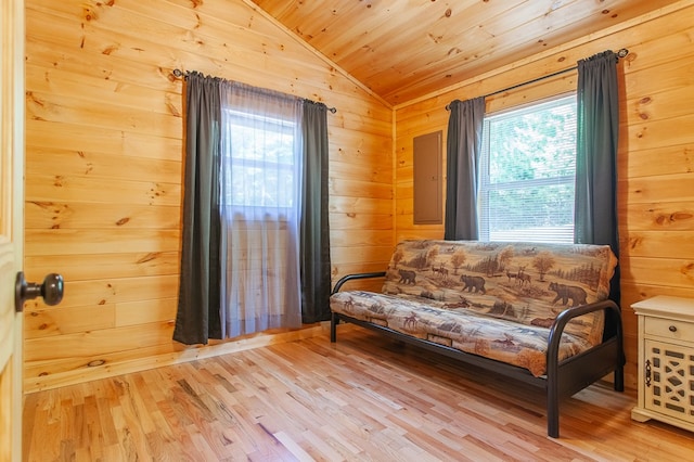 living area with wooden ceiling, lofted ceiling, wood walls, and light hardwood / wood-style floors