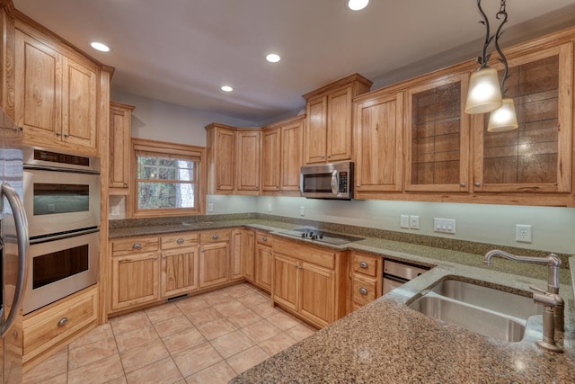 kitchen with appliances with stainless steel finishes, sink, light tile patterned floors, pendant lighting, and stone countertops