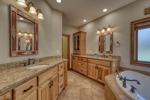 bathroom featuring vanity and a relaxing tiled tub