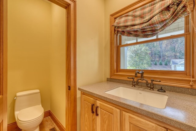 bathroom featuring vanity and toilet