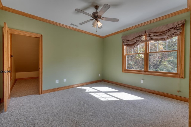 carpeted empty room with ceiling fan and crown molding