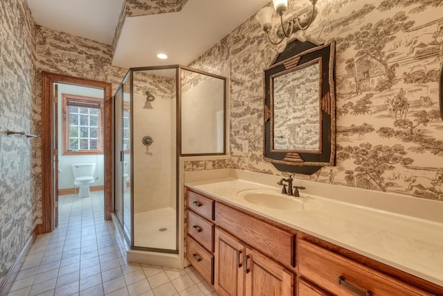 bathroom with tile patterned flooring, vanity, toilet, and walk in shower