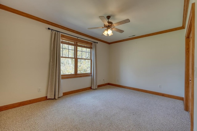 empty room featuring light colored carpet and crown molding