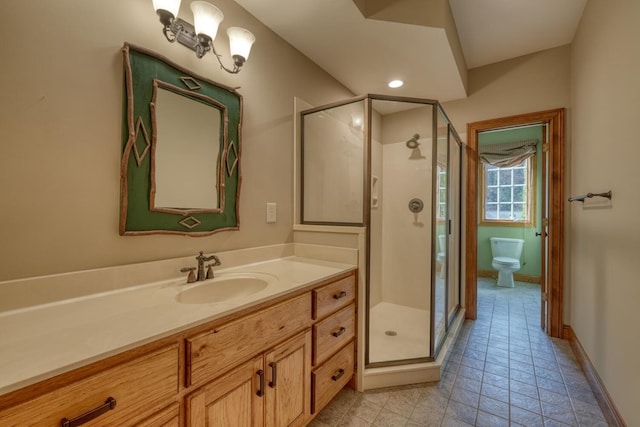 bathroom with vanity, toilet, and walk in shower