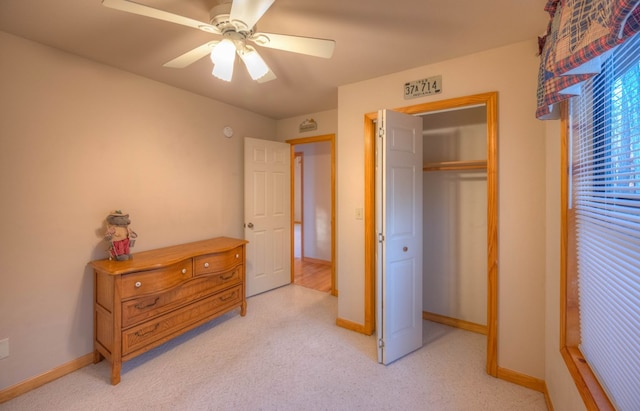 bedroom featuring ceiling fan, light colored carpet, and a closet