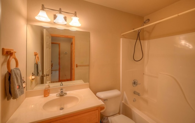 full bathroom featuring vanity, washtub / shower combination, and toilet