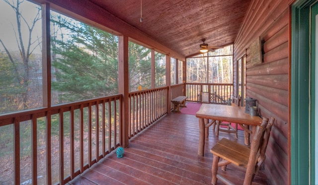 unfurnished sunroom with wood ceiling, ceiling fan, plenty of natural light, and vaulted ceiling