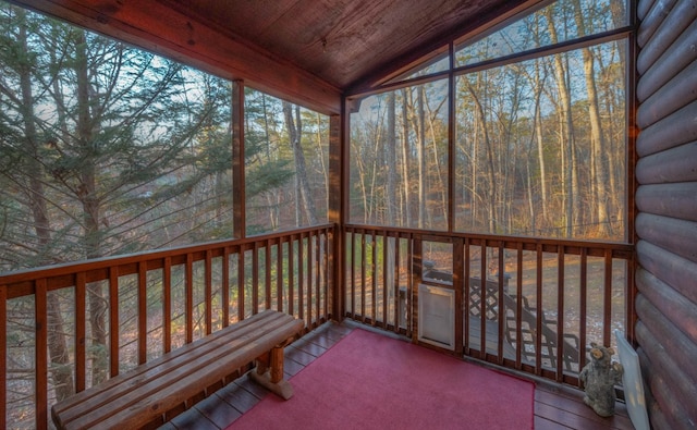 unfurnished sunroom featuring lofted ceiling and wooden ceiling