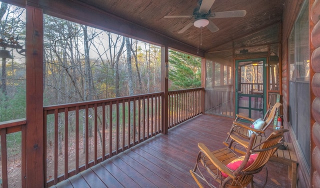 sunroom featuring lofted ceiling, plenty of natural light, wooden ceiling, and ceiling fan