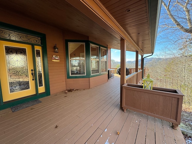 wooden deck featuring a mountain view and a porch