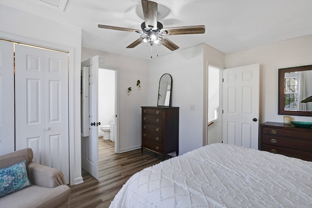 bedroom featuring dark wood-type flooring, ceiling fan, ensuite bathroom, and a closet