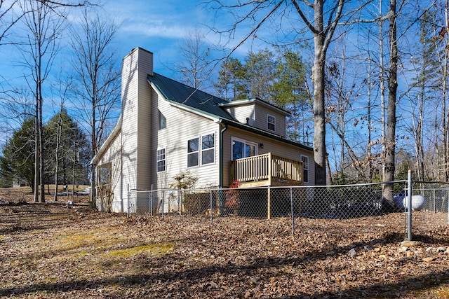 view of side of property featuring a wooden deck