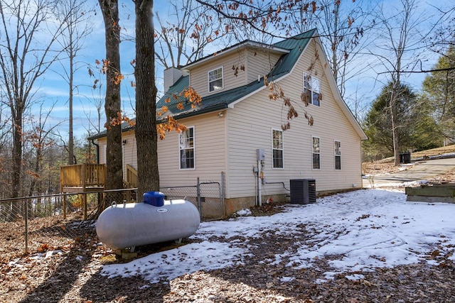 snow covered back of property with cooling unit