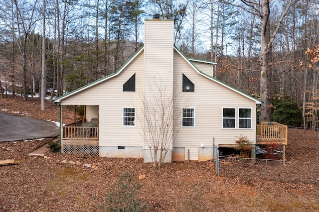 view of home's exterior with a deck and a porch