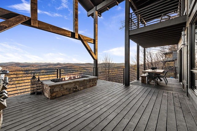 deck featuring a mountain view and an outdoor fire pit