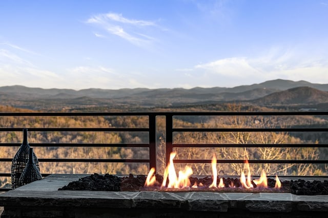 exterior space with a mountain view and a fireplace