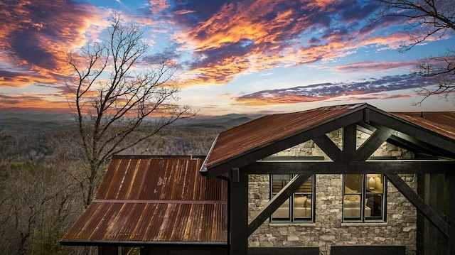 property exterior at dusk with a mountain view