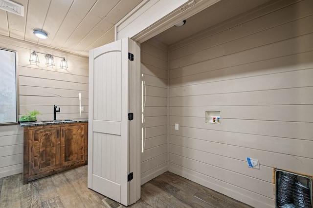 washroom featuring hardwood / wood-style floors, hookup for a washing machine, wooden ceiling, and sink