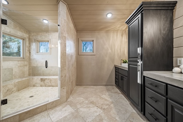 bathroom with vanity, a shower with door, and wooden ceiling