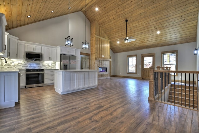 kitchen with backsplash, ceiling fan, open floor plan, wood ceiling, and stainless steel appliances