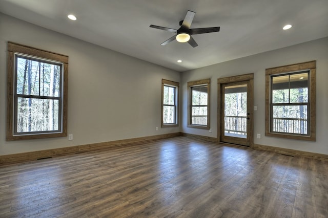 empty room with visible vents, dark wood finished floors, recessed lighting, baseboards, and ceiling fan