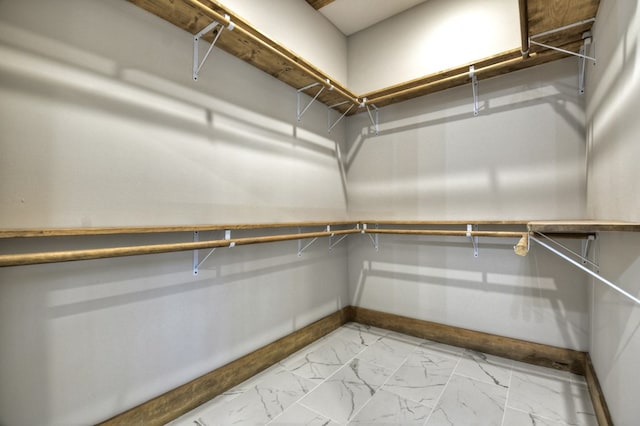 spacious closet with marble finish floor