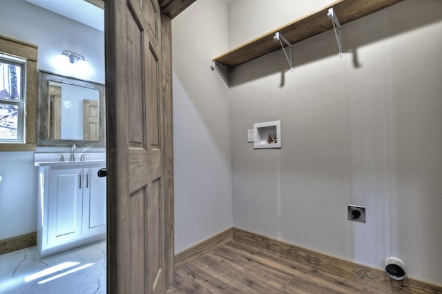 laundry room with wood finished floors, hookup for an electric dryer, laundry area, a sink, and washer hookup