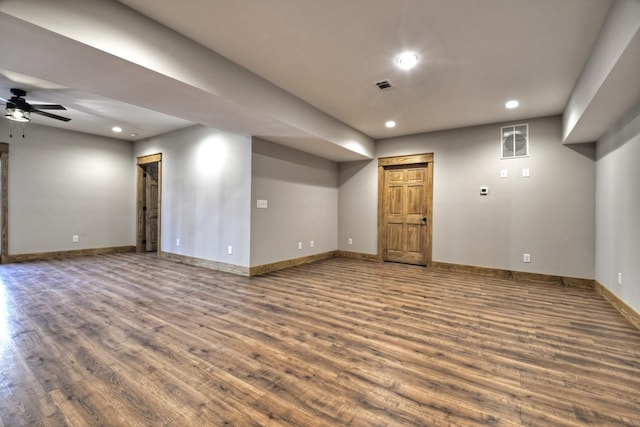 finished basement with visible vents, recessed lighting, baseboards, and wood finished floors