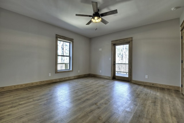 unfurnished room with wood finished floors, baseboards, a wealth of natural light, and ceiling fan